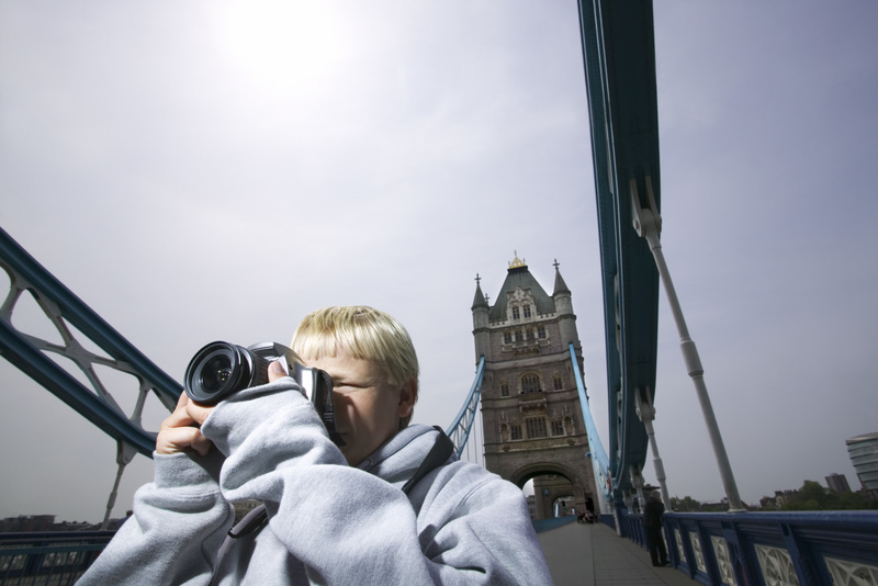 پسری در حال عکس گرفتن در پل تاور، لندن، انگلستان